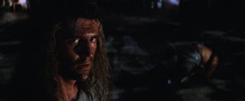 Movie still from “Mad Max Beyond Thunderdome” (1985), directed by George Miller – A person with long brown hair; Close Up shot, Low angle