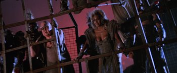 Movie still from “Mad Max Beyond Thunderdome” (1985), directed by George Miller – A group of people dressed up in costumes; Medium shot, Low angle