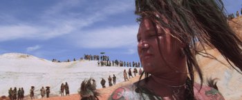 Movie still from “Mad Max Beyond Thunderdome” (1985), directed by George Miller – A person with a bunch of tattoos on their head; Close Up shot, Low angle