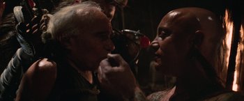 Movie still from “Mad Max Beyond Thunderdome” (1985), directed by George Miller – A man and a woman are talking to each other; Close Up shot, Over the shoulder angle