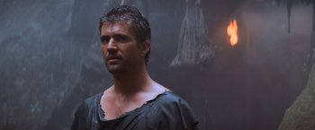 Movie still from “Mad Max Beyond Thunderdome” (1985), directed by George Miller – A person wearing a black shirt; Close Up shot, Low angle