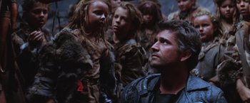Movie still from “Mad Max Beyond Thunderdome” (1985), directed by George Miller – A group of young people dressed in animal skins; Medium shot, Low angle