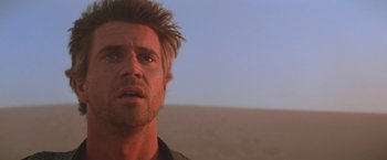Movie still from “Mad Max Beyond Thunderdome” (1985), directed by George Miller – A person looking at the camera; Close Up shot, Low angle