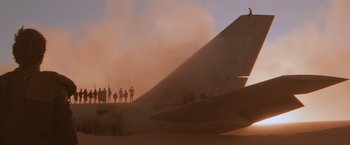 Movie still from “Mad Max Beyond Thunderdome” (1985), directed by George Miller – A group of people standing on top of a sand dune; Extreme Wide shot, Low angle