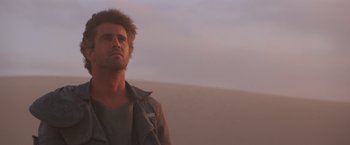 Movie still from “Mad Max Beyond Thunderdome” (1985), directed by George Miller – A man standing in the desert looking into the distance; Close Up shot, Low angle