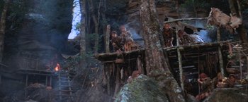 Movie still from “Mad Max Beyond Thunderdome” (1985), directed by George Miller – A group of people standing on top of a wooden structure; Wide shot, Low angle