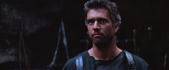 Movie still from “Mad Max Beyond Thunderdome” (1985), directed by George Miller – A person wearing a black shirt; Close Up shot, Low angle