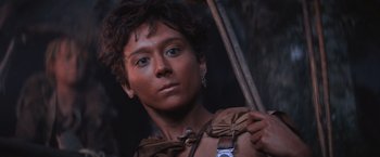 Movie still from “Mad Max Beyond Thunderdome” (1985), directed by George Miller – A young man holding an umbrella while standing in the dark; Close Up shot, High angle