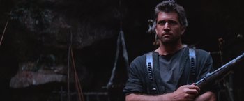 Movie still from “Mad Max Beyond Thunderdome” (1985), directed by George Miller – A person wearing a black shirt; Close Up shot, Low angle