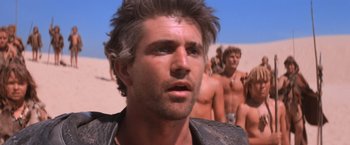 Movie still from “Mad Max Beyond Thunderdome” (1985), directed by George Miller – A person wearing a leather jacket; Close Up shot, Low angle