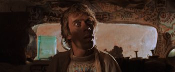 Movie still from “Mad Max Beyond Thunderdome” (1985), directed by George Miller – A man with a surprised look on his face; Close Up shot, Low angle