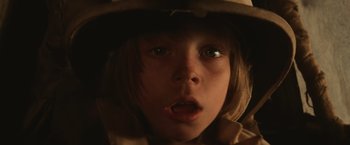Movie still from “Mad Max Beyond Thunderdome” (1985), directed by George Miller – A child's face with a hat on; Close Up shot, Low angle