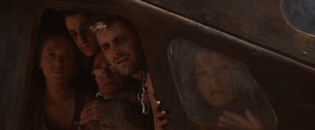 Movie still from “Mad Max Beyond Thunderdome” (1985), directed by George Miller – A man and a woman looking out of a car window; Close Up shot, Low angle
