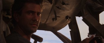 Movie still from “Mad Max Beyond Thunderdome” (1985), directed by George Miller – A man's face in a plane; Close Up shot, Low angle