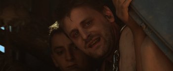 Movie still from “Mad Max Beyond Thunderdome” (1985), directed by George Miller – A man and a woman are looking at the camera; Close Up shot, Low angle