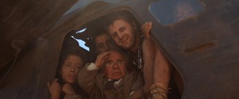Movie still from “Mad Max Beyond Thunderdome” (1985), directed by George Miller – An old man and three young people in a car; Medium shot, Low angle