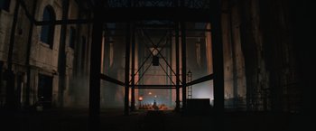 Movie still from “Mad Max Beyond Thunderdome” (1985), directed by George Miller – A stage is lit up in the dark with lights; Extreme Wide shot, Low angle