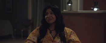 Movie still from “Madres” (2021), directed by Ryan Zaragoza – A woman with long black hair sitting in a room; Close Up shot, Over the shoulder angle