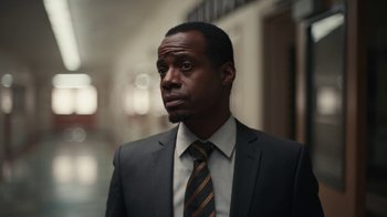 Movie still from “Euphoria” (2019), created by Sam Levinson – A man in a suit and tie looking to his left; Close Up shot, Low angle
