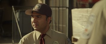 Movie still from “Maggie Moore(s)” (2023), directed by John Slattery – A person wearing a uniform and a hat; Close Up shot, Over the shoulder angle