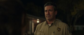 Movie still from “Maggie Moore(s)” (2023), directed by John Slattery – A person wearing a police uniform; Close Up shot, Over the shoulder angle