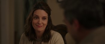 Movie still from “Maggie Moore(s)” (2023), directed by John Slattery – A person sitting at a table; Close Up shot, Over the shoulder angle