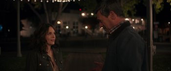 Movie still from “Maggie Moore(s)” (2023), directed by John Slattery – A man and a woman talking to each other outside at night; Medium shot, Over the shoulder angle