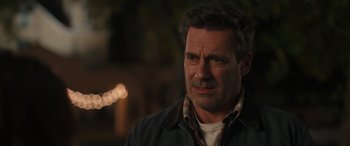 Movie still from “Maggie Moore(s)” (2023), directed by John Slattery – A person wearing a jacket; Close Up shot, Over the shoulder angle