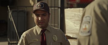 Movie still from “Maggie Moore(s)” (2023), directed by John Slattery – A man in a brown hat and a brown uniform; Close Up shot, Over the shoulder angle