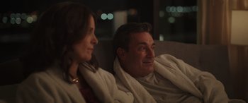 Movie still from “Maggie Moore(s)” (2023), directed by John Slattery – A man and a woman wrapped in a blanket; Medium shot, Over the shoulder angle