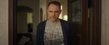 Movie still from “Maggie Moore(s)” (2023), directed by John Slattery – A person wearing a t - shirt; Close Up shot, Low angle