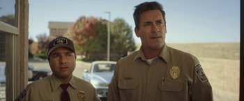 Movie still from “Maggie Moore(s)” (2023), directed by John Slattery – A man and a woman standing next to each other in a parking lot; Close Up shot, Over the shoulder angle