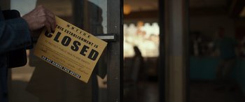 Movie still from “Maggie Moore(s)” (2023), directed by John Slattery – A sign hanging on the door of a restaurant; Extreme Close Up shot, High angle