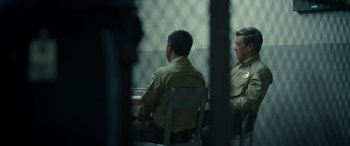 Movie still from “Maggie Moore(s)” (2023), directed by John Slattery – Two police officers are sitting in a jail cell; Medium shot, Over the shoulder angle