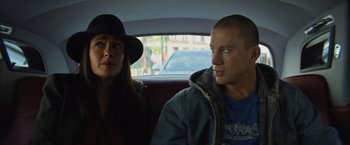 Movie still from “Magic Mike's Last Dance” (2023), directed by Steven Soderbergh – A man and a woman sitting in the back of a car; Close Up shot, Over the shoulder angle