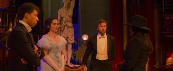 Movie still from “Magic Mike's Last Dance” (2023), directed by Steven Soderbergh – A man and a woman standing next to each other in front of a statue; Medium shot, Low angle