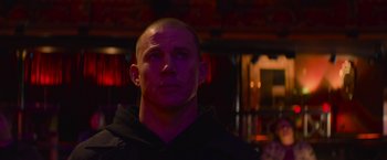 Movie still from “Magic Mike's Last Dance” (2023), directed by Steven Soderbergh – A man with a bald head is standing in a room; Close Up shot, Low angle