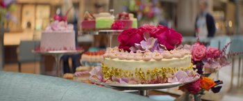 Movie still from “Magic Mike's Last Dance” (2023), directed by Steven Soderbergh – A cake on a plate on the table; Extreme Close Up shot, Overhead angle