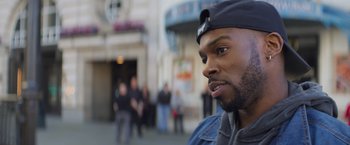 Movie still from “Magic Mike's Last Dance” (2023), directed by Steven Soderbergh – A person wearing a hat; Close Up shot, Over the shoulder angle