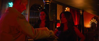 Movie still from “Magic Mike's Last Dance” (2023), directed by Steven Soderbergh – Two women are sitting at a table in front of a mirror; Medium shot, Over the shoulder angle
