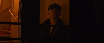 Movie still from “Magic Mike's Last Dance” (2023), directed by Steven Soderbergh – A man wearing a hat looking into a mirror; Close Up shot, Low angle
