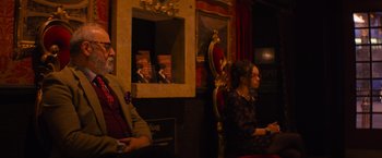 Movie still from “Magic Mike's Last Dance” (2023), directed by Steven Soderbergh – A man and a woman are sitting in a room; Medium shot, Over the shoulder angle