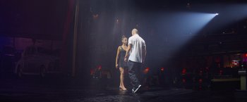 Movie still from “Magic Mike's Last Dance” (2023), directed by Steven Soderbergh – A man and a woman are dancing on a stage; Wide shot, Low angle