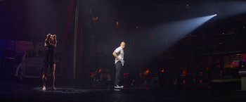 Movie still from “Magic Mike's Last Dance” (2023), directed by Steven Soderbergh – A man standing on a stage in front of a crowd; Wide shot, Low angle