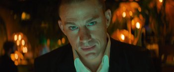 Movie still from “Magic Mike's Last Dance” (2023), directed by Steven Soderbergh – A person wearing a suit and tie; Close Up shot, Low angle