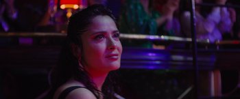 Movie still from “Magic Mike's Last Dance” (2023), directed by Steven Soderbergh – A person sitting in a room; Close Up shot, Over the shoulder angle