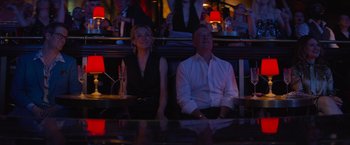 Movie still from “Magic Mike's Last Dance” (2023), directed by Steven Soderbergh – A man and a woman sitting at a table in a bar; Medium shot, Low angle