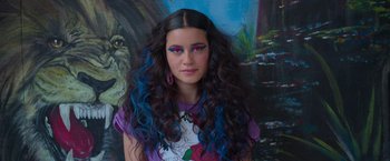 Movie still from “Making It Up” (2023), directed by Guillermo Calderón – A woman with blue and purple hair and pink eye shadow; Close Up shot, Overhead angle