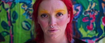 Movie still from “Making It Up” (2023), directed by Guillermo Calderón – A person with red hair and a nose ring; Extreme Close Up shot, Overhead angle