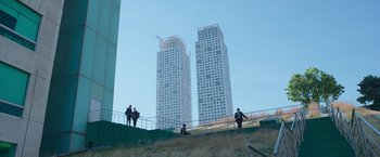 Movie still from “Making It Up” (2023), directed by Guillermo Calderón – A group of people standing next to each other on top of a hill; Extreme Wide shot, Low angle